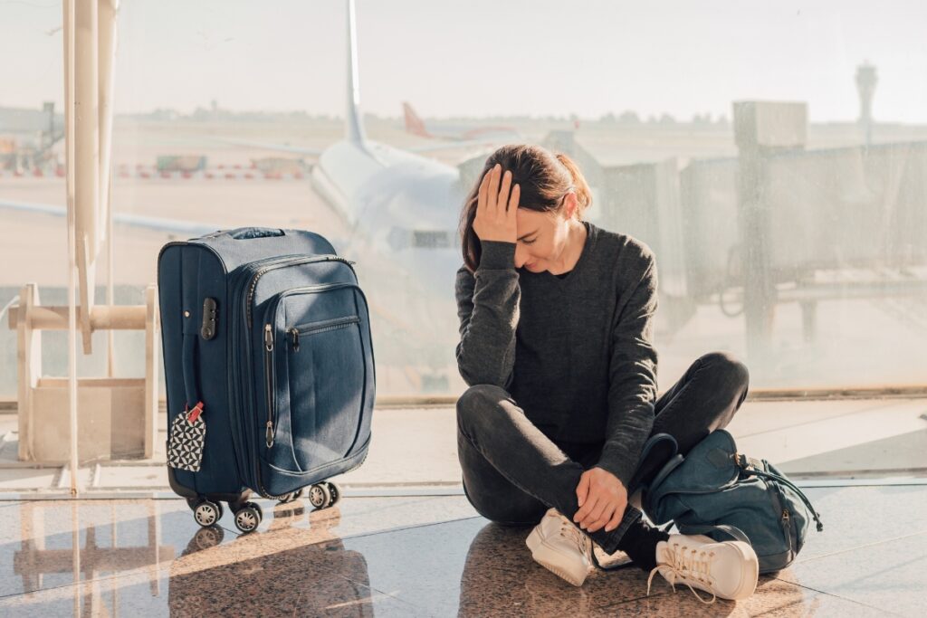 woman feeling overwhelmed in an airport. HSP